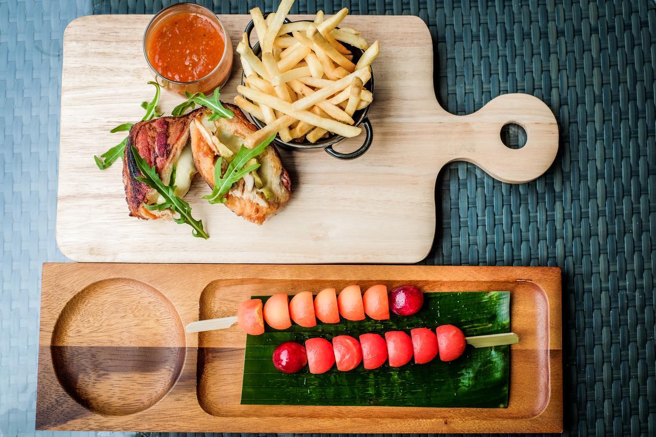 Fusion Suites Phuket Patong Екстериор снимка A wooden cutting board with a handle
